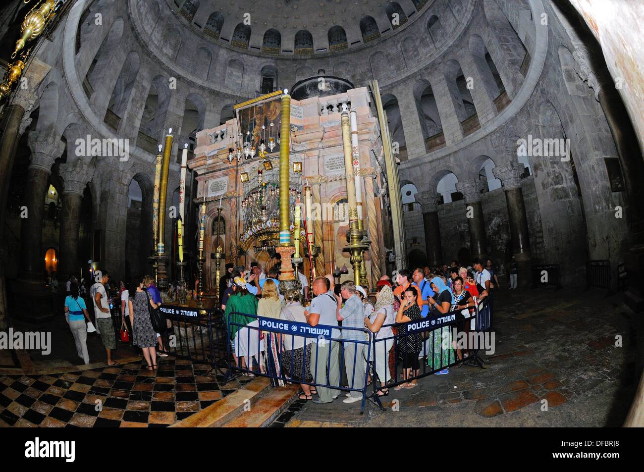 The most important site of the Church of the Holy Sepulchre is the Aedicule (Holy Grave, Grave Chapel), the supposed location of Jesus' grave and the 14th statio of the Via Dolorosa, that is visited by thousands of pilgrims and tourists daily, in Jerusalem, Israel, 12 September 2013. The Via Dolorosa (Way of Suffering) is a street in the old town of Jerusalem named after the path Jesus of Nazareth walked to his crucification. Jesus carried the cross, on which he later died via that road from the Antonia Fortress, then seat of Pilate, to Golgotha, the place where his grave is supposedly located Stock Photo