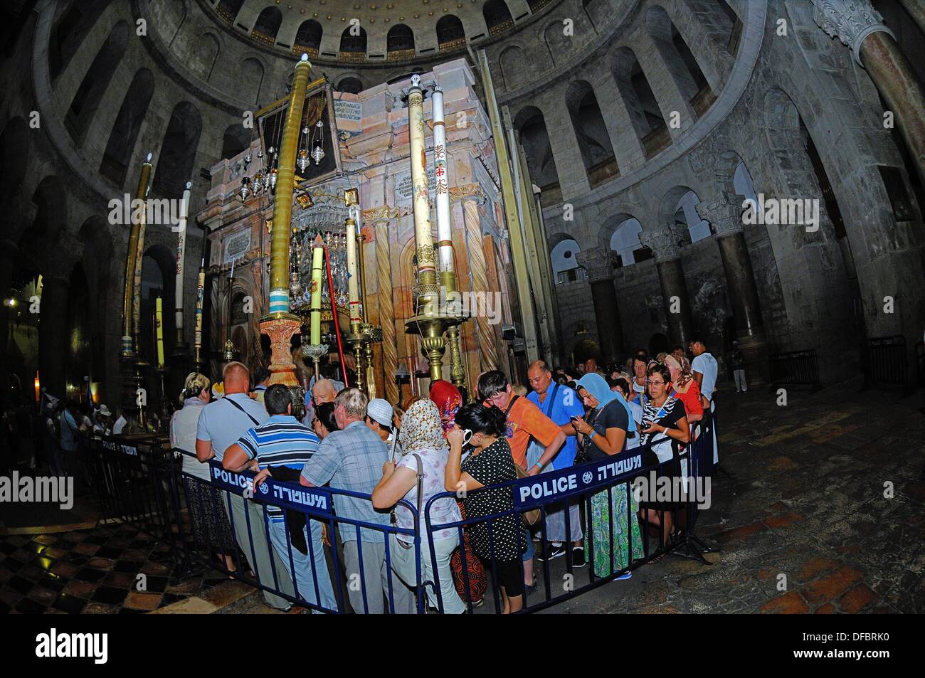 The most important site of the Church of the Holy Sepulchre is the Aedicule (Holy Grave, Grave Chapel), the supposed location of Jesus' grave and the 14th station of the Via Dolorosa, that is visited by thousands of pilgrims and tourists daily, in Jerusalem, Israel, 12 September 2013. The Via Dolorosa (Way of Suffering) is a street in the old town of Jerusalem named after the path Jesus of Nazareth walked to his crucification. Jesus carried the cross, on which he later died via that road from the Antonia Fortress, then seat of Pilate, to Golgotha, the place where his grave is supposedly locate Stock Photo