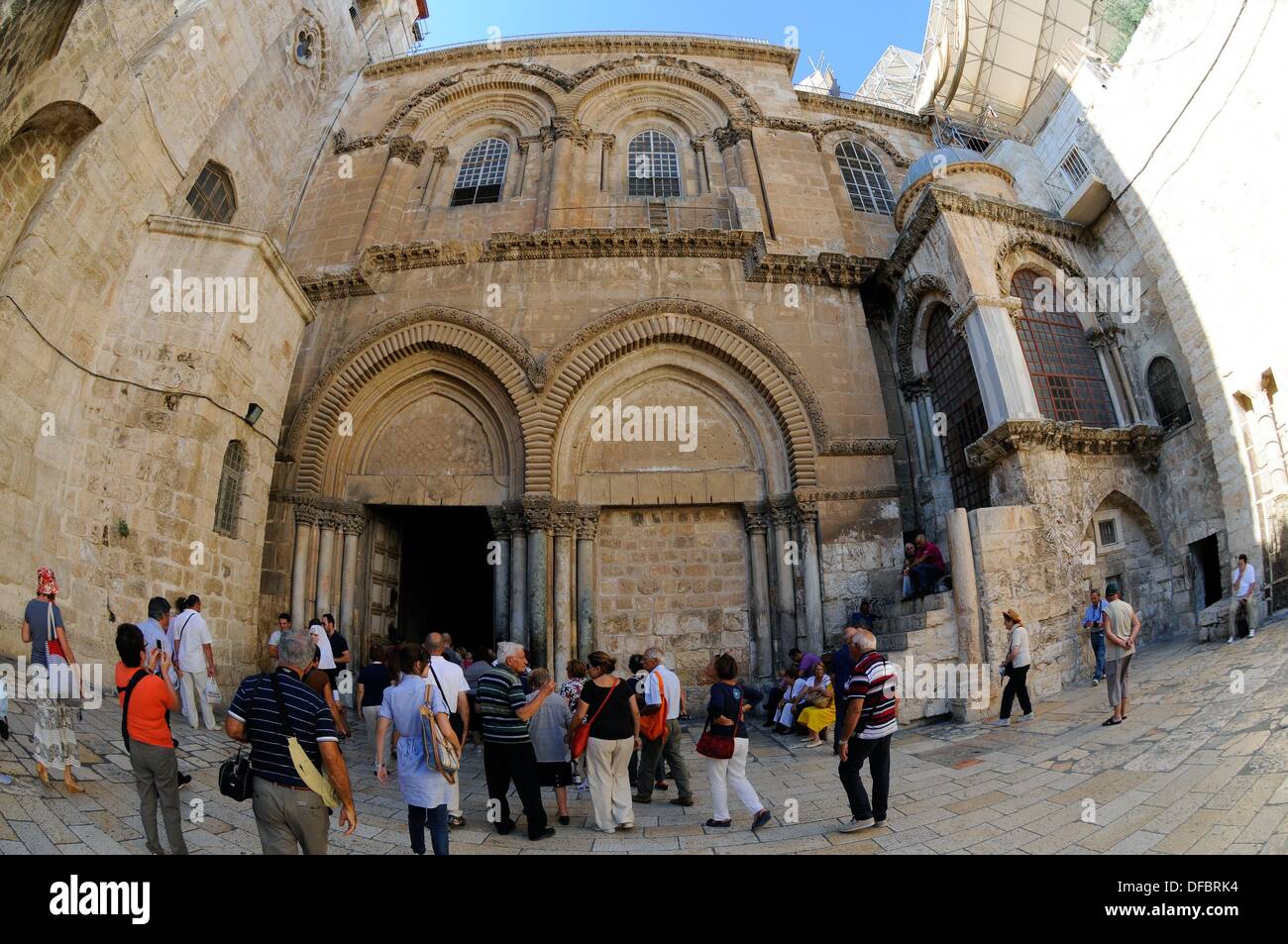 View of the entrance of the Church of the Holy Sepulchre, which contains the last five stations of the Via Dolorosa, in Jerusalem, Israel, 10 September 2013. The Via Dolorosa (Way of Suffering) is a street in the old town of Jerusalem named after the path Jesus of Nazareth walked to his crucification. Jesus carried the cross, on which he later died via that road from the Antonia Fortress, then seat of Pilate, to Golgotha, the place where his grave is supposedly located. Above this place, the Church of the Holy Sepulchre was later built. The path led Jesus via 14 stations that are often visited Stock Photo