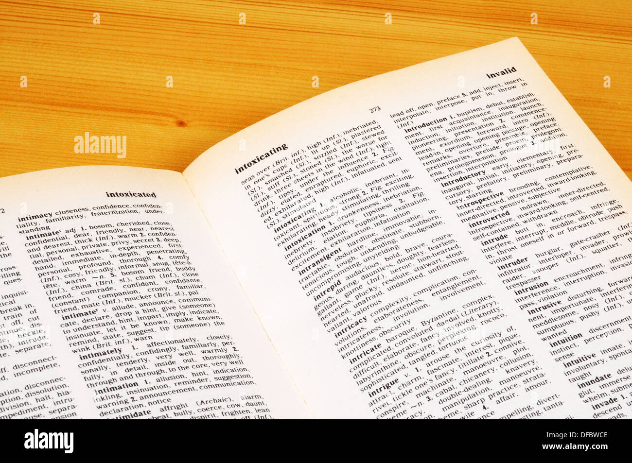 Pages of a Thesaurus against wooden background. Stock Photo