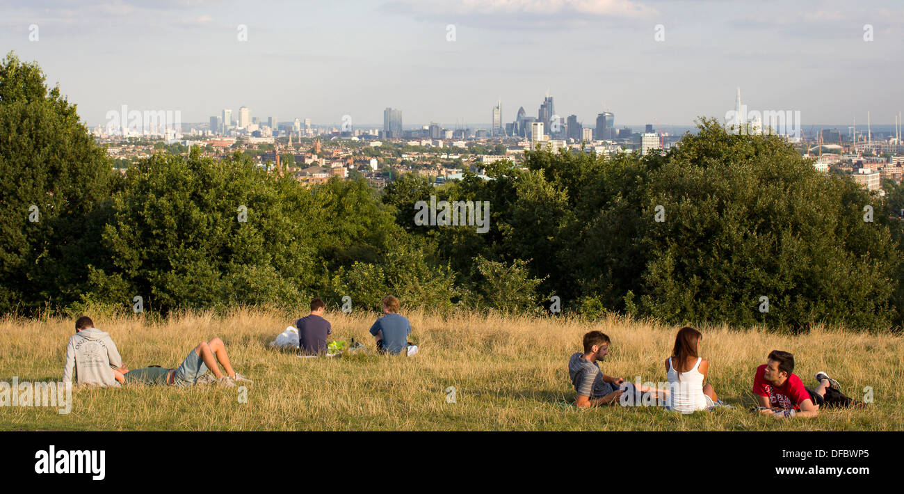 UK, London : People sit and look at the view over London on Hampstead Heath in London on August 28, 2013. Stock Photo