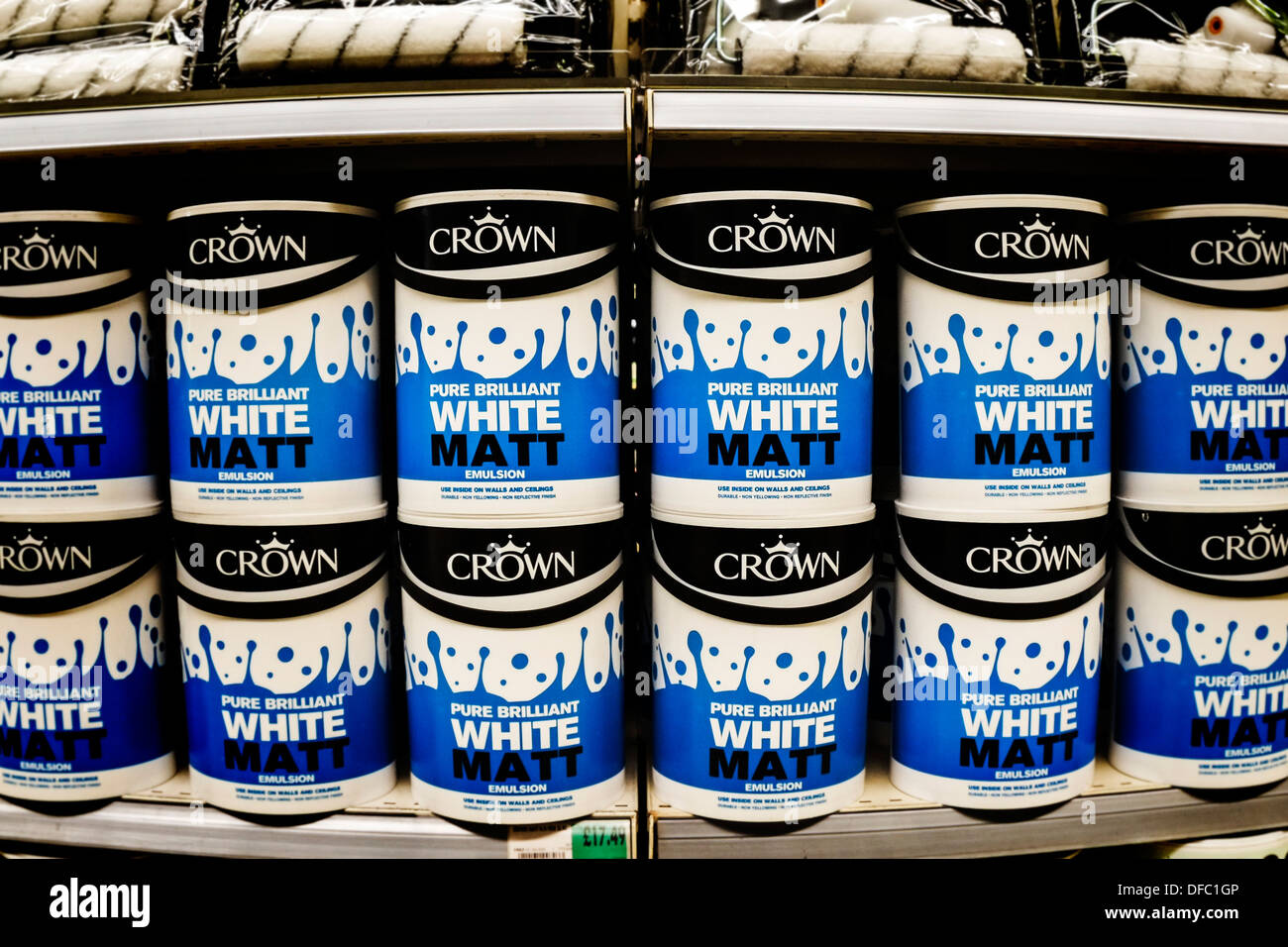 Shelves containing large tins of Crown paint Stock Photo Alamy