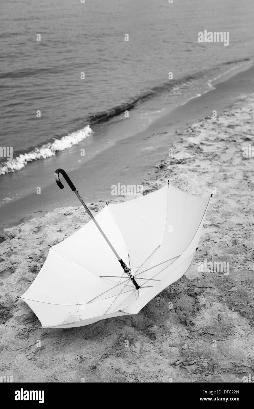 white umbrella on the sand Stock Photo