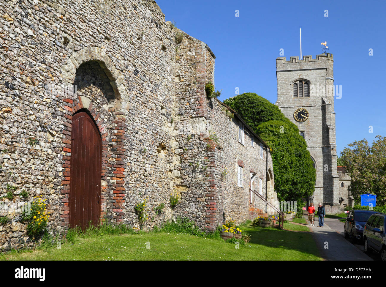 St Peter and St Paul church, couple walking by the ruins of the Archbishop's Palace, Charing Kent UK Stock Photo