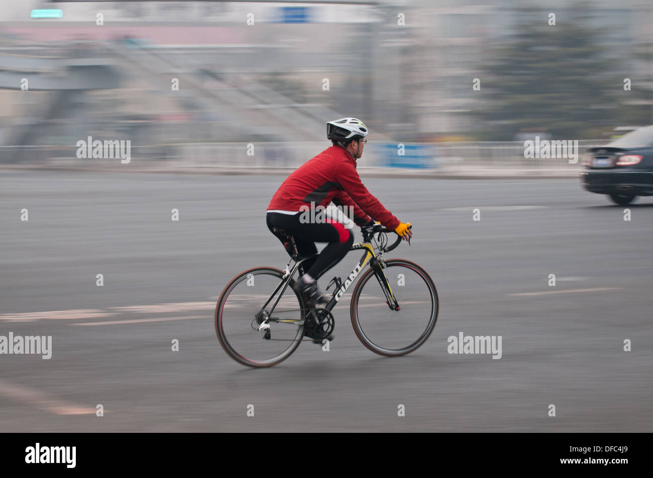 Man riding on cycling bike in Beijing, China Stock Photo