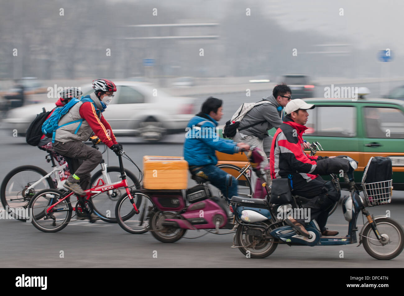 Chinese people on bikes and scooters in Beijing, China Stock Photo
