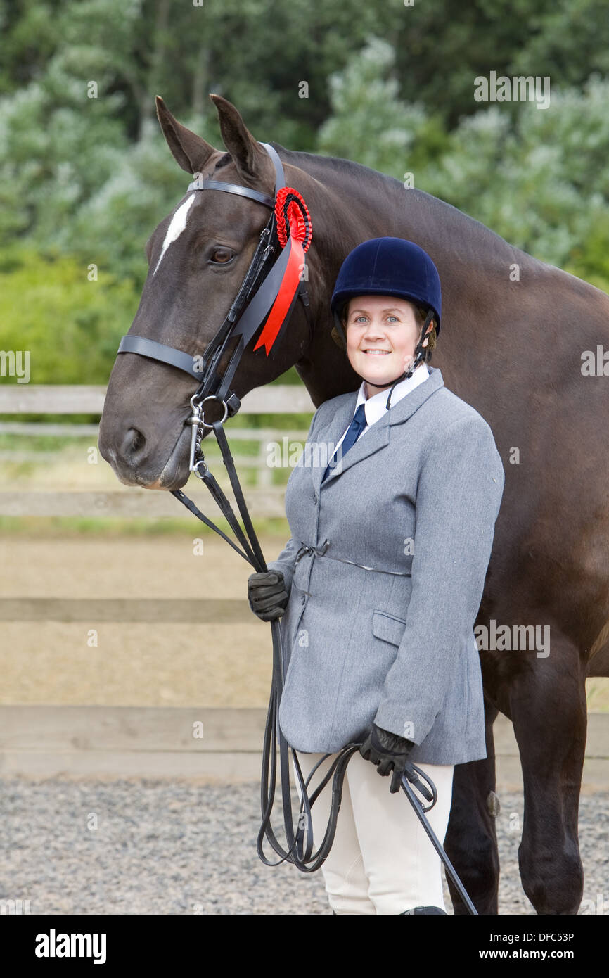 A competitor with their horse at an outdoor equestrian competition Stock Photo