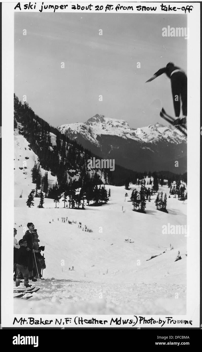 A ski jumper in mid-air about 20 feet from the snow take-off point in Heather Meadows, Mount Baker National Forest in 1936. The photo captures a moment during the sport's early competitive years. Stock Photo
