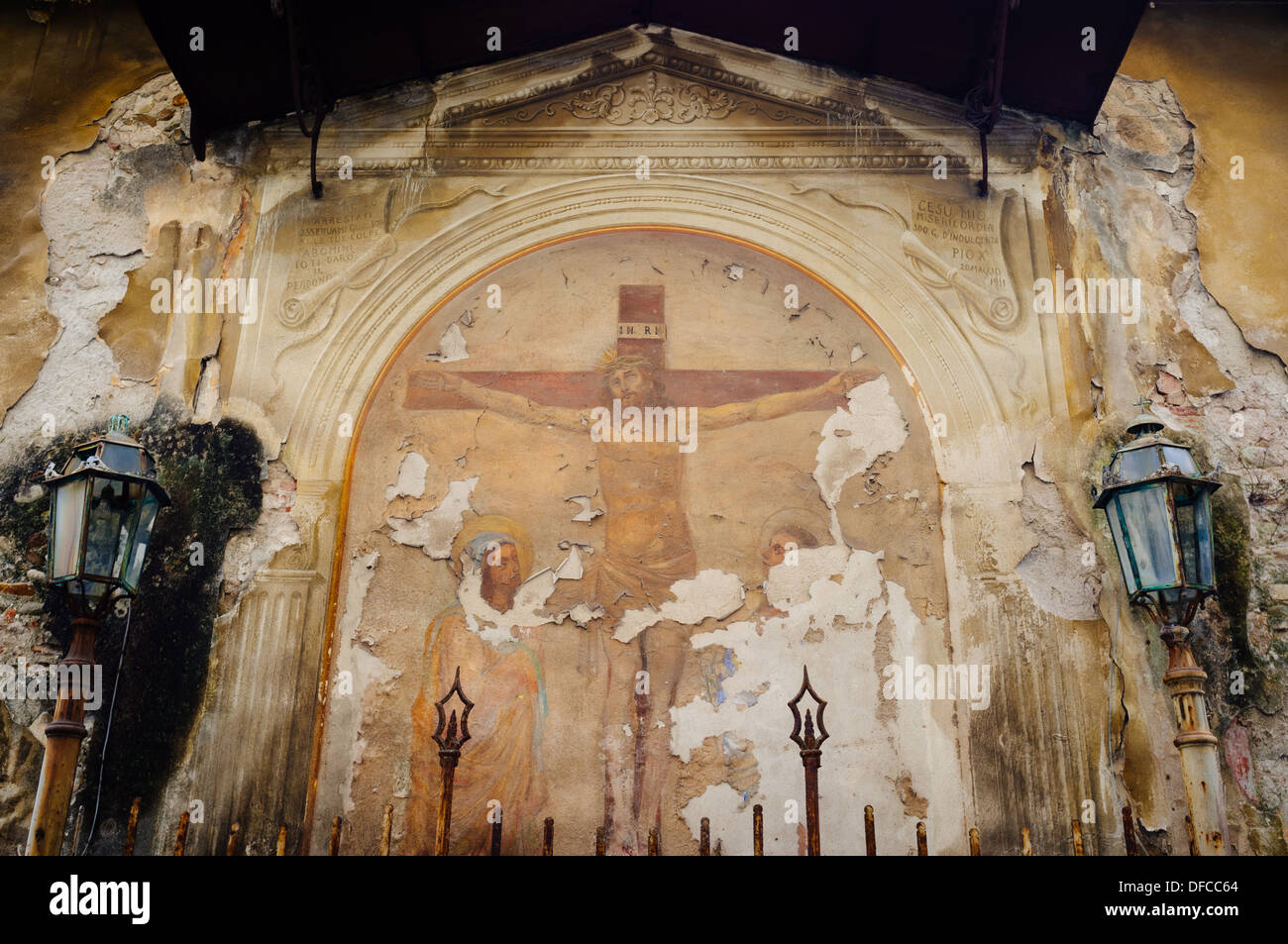 Weathered Fresco depicting Jesus on the cross - Lucca, Italy Stock Photo