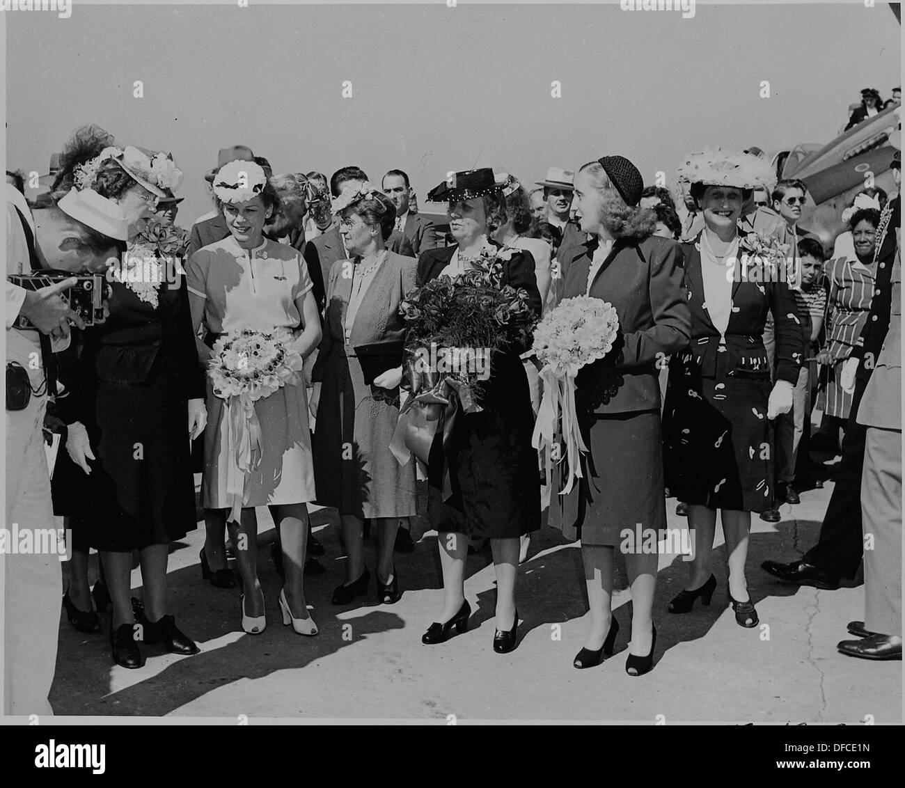 Bess Truman and Margaret Truman hold bouquets during the christening