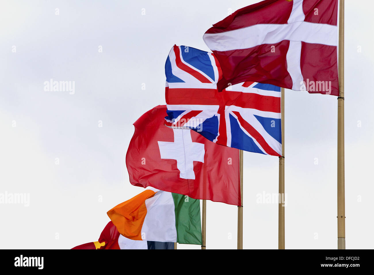 Flying flags of Denmark, United Kingdom, Switzerland and Ireland Stock Photo