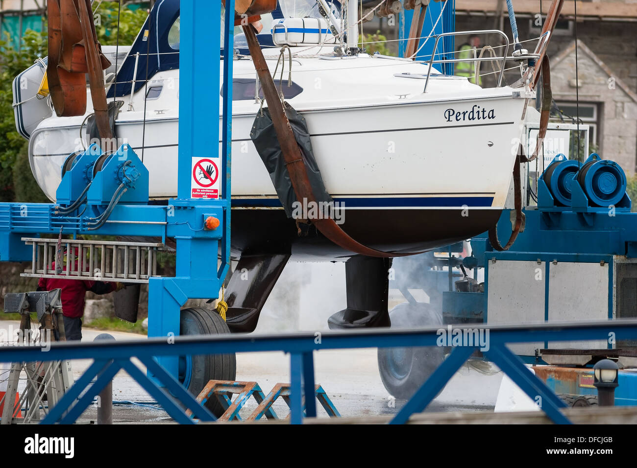 boatyard workman steam cleaning boat on hoist Stock Photo Alamy
