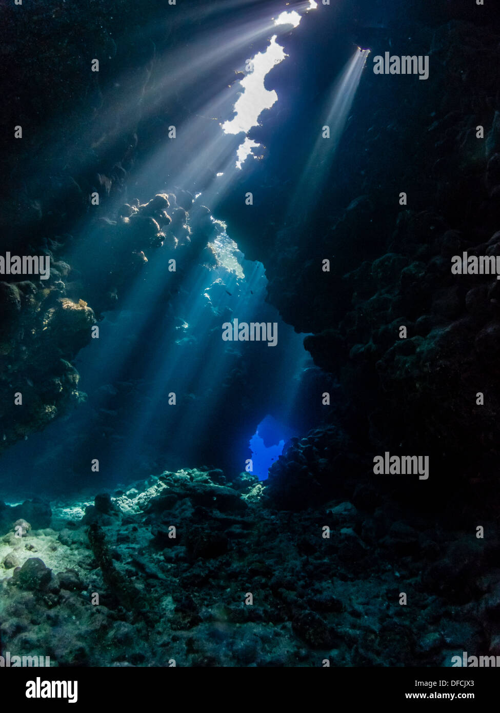 Scuba diving in the beautiful swimthroughs & dramatic light of Sha'ab Claudio, Egypt Stock Photo