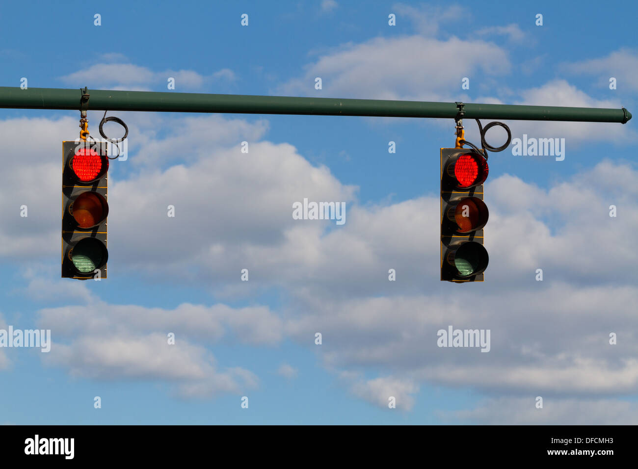 Traffic signal, stop light, red light, or traffic light.  Blue sky with white clouds in the background Stock Photo