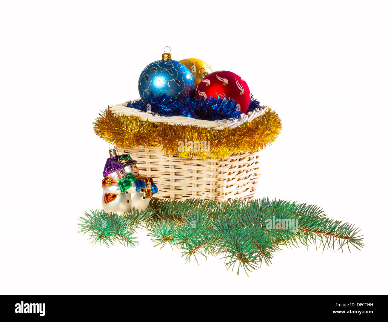 Decorated Christmas basket with Christmas toys and tinsel Stock Photo