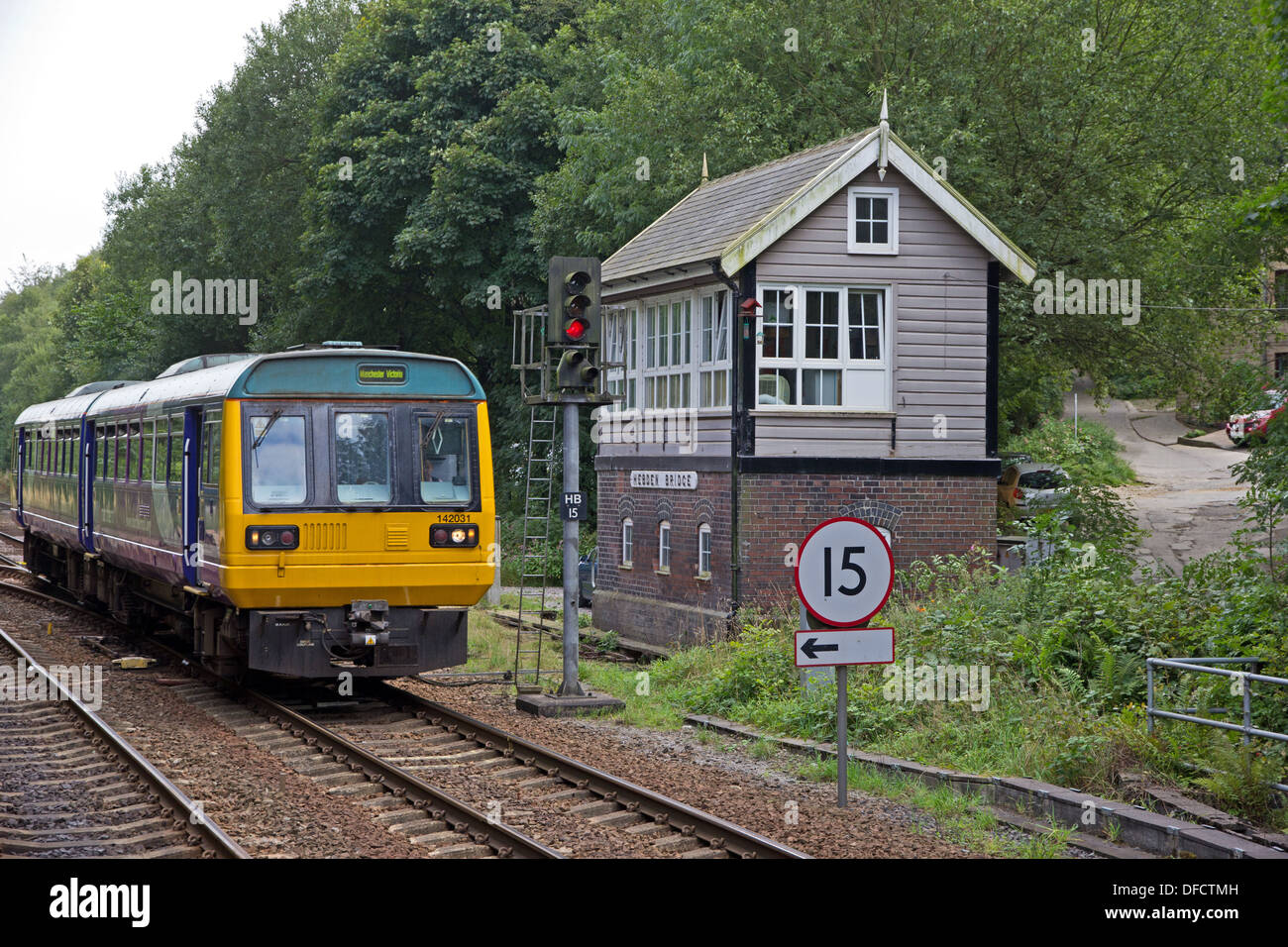 Northern Rail Pacer train passing Railway signal box, Hebden Bridge Stock Photo