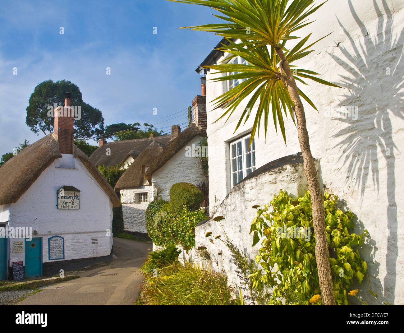 Pretty traditional thatched cottages in the village of Helford village, Cornwall, England Stock Photo