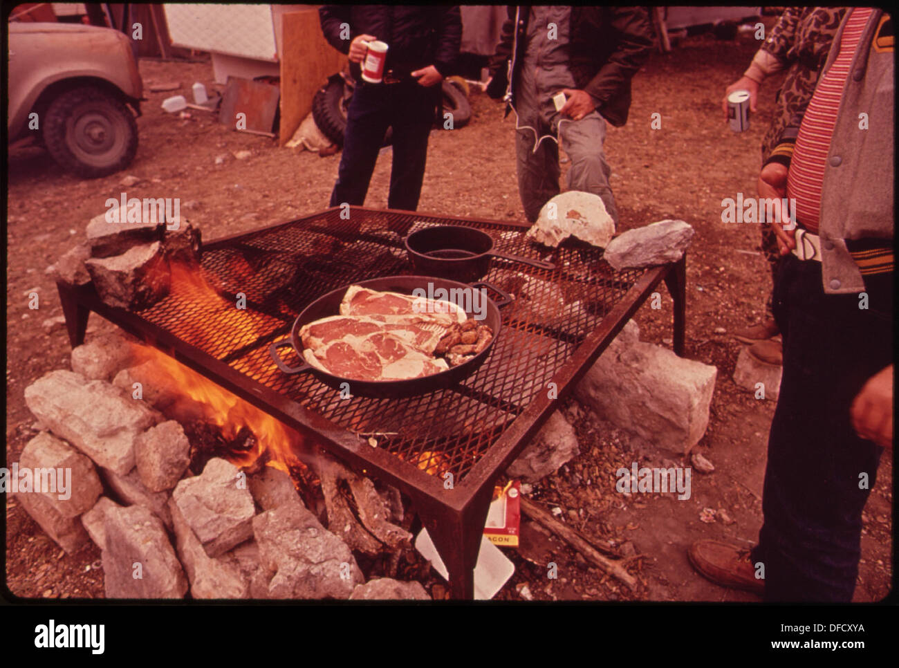Deer hunters prepare their evening meal at a permanent camp near wild ...