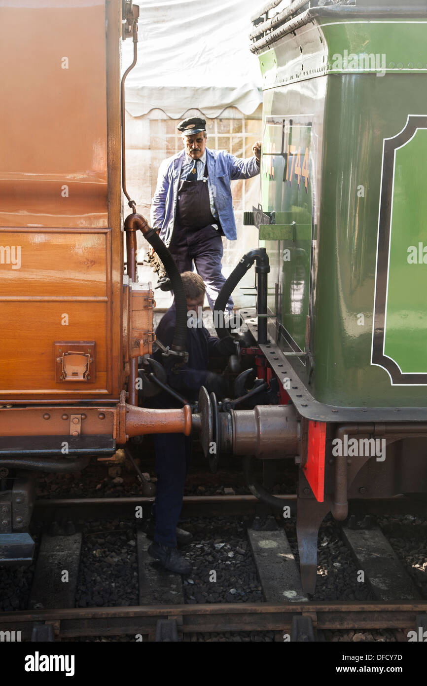 Engineers coupling a carriage to a tender Sheringham Norfolk Stock Photo