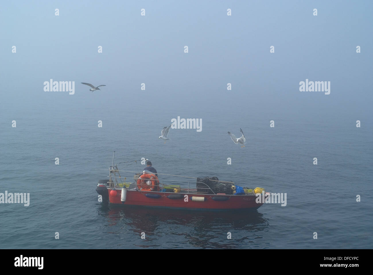 Artisan fisherman working in the mist Stock Photo