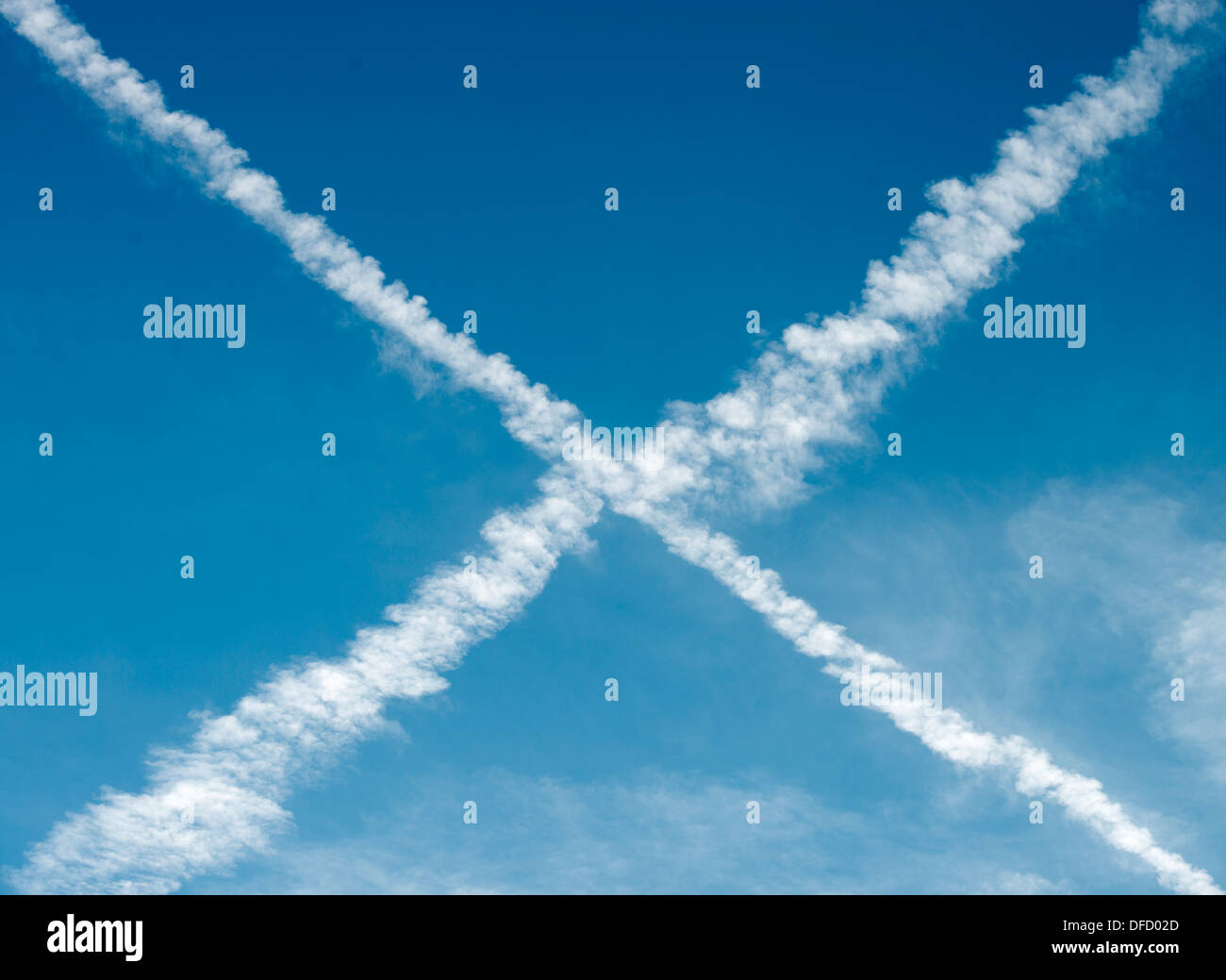 Vapour trails from aircraft forming an cross Stock Photo
