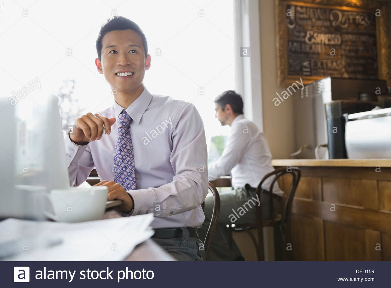 Businessman working remotely on a laptop in a cafe Stock Photo