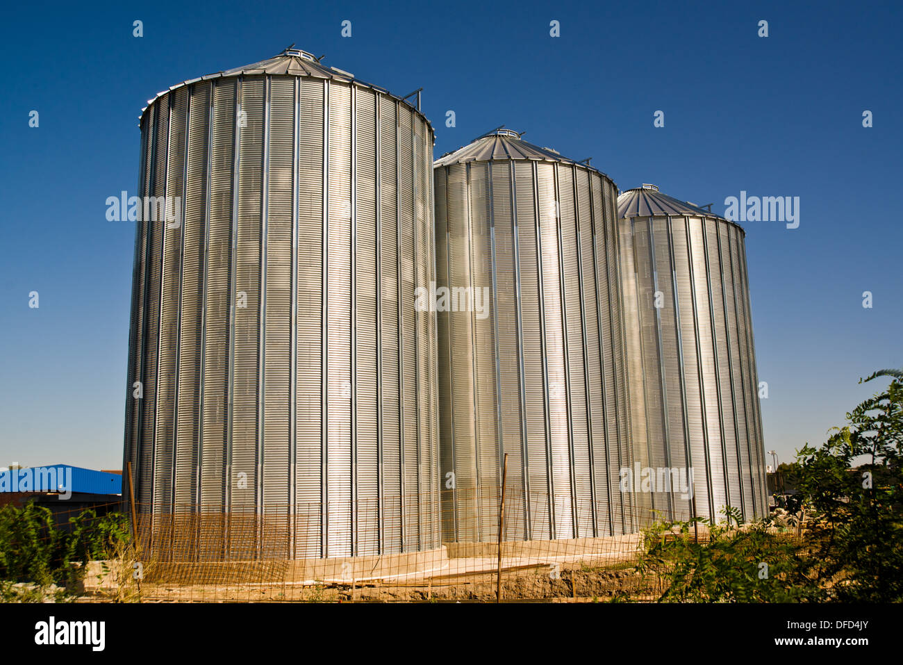 Grain silos construction site in finishing phase. Stock Photo