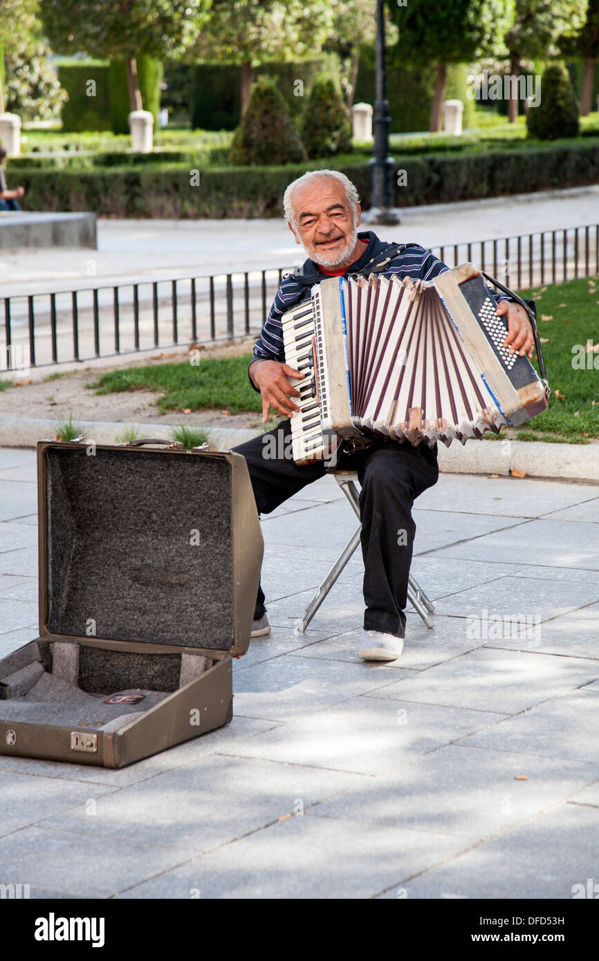 Street artist playing the concertina. Stock Photo