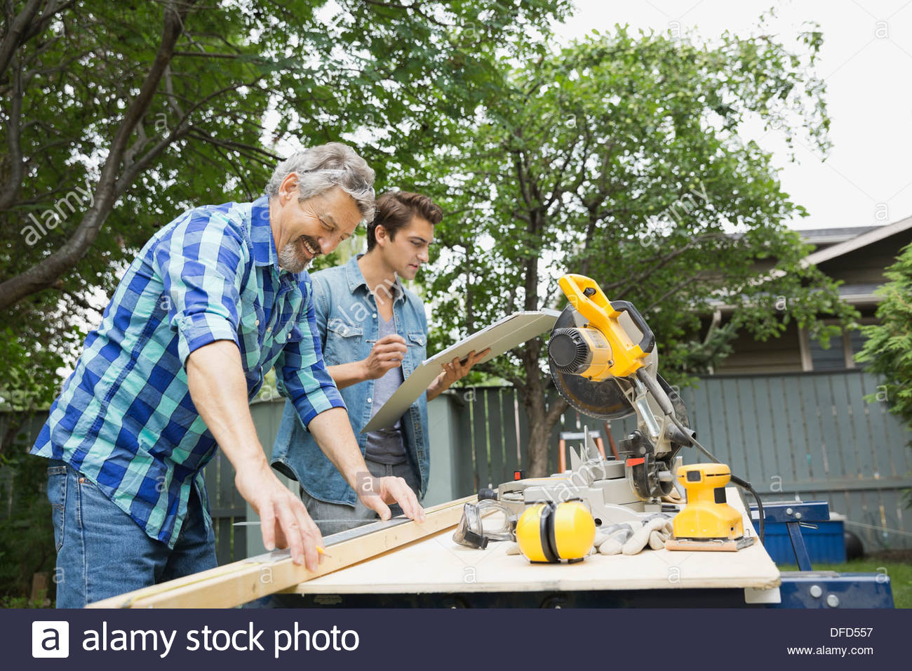 Father and son constructing a project in backyard Stock Photo