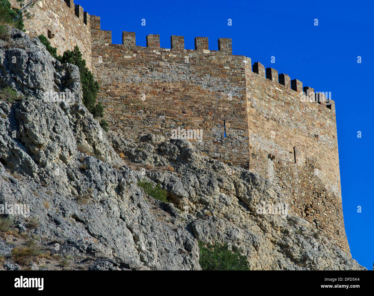 Ruins of an ancient Genoa Fortress on a mountain in Sudak, Crimea, Ukraine. Situated on rocky mountains with blue sky Stock Photo