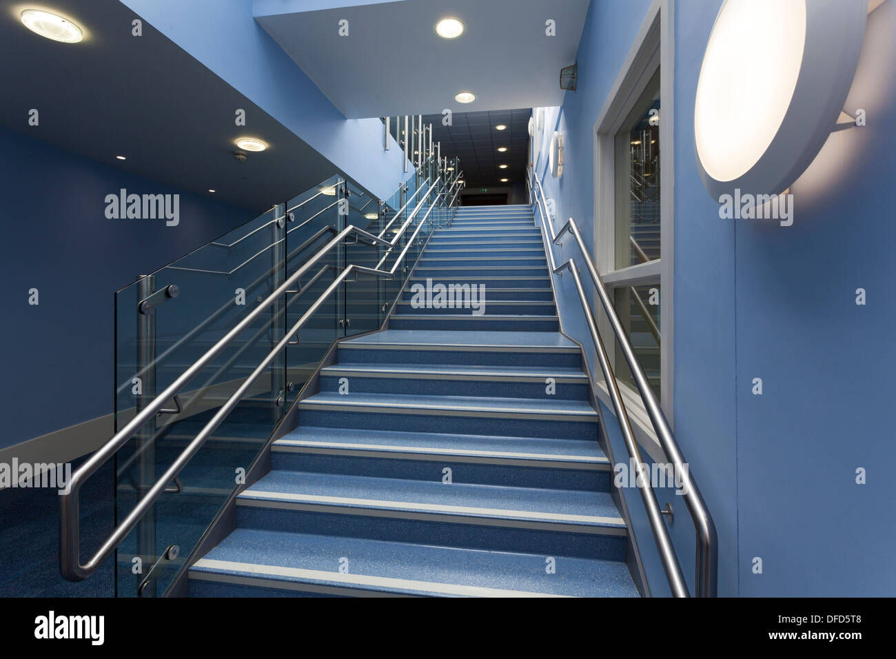 wide interior staircase and hand rail in school Stock Photo