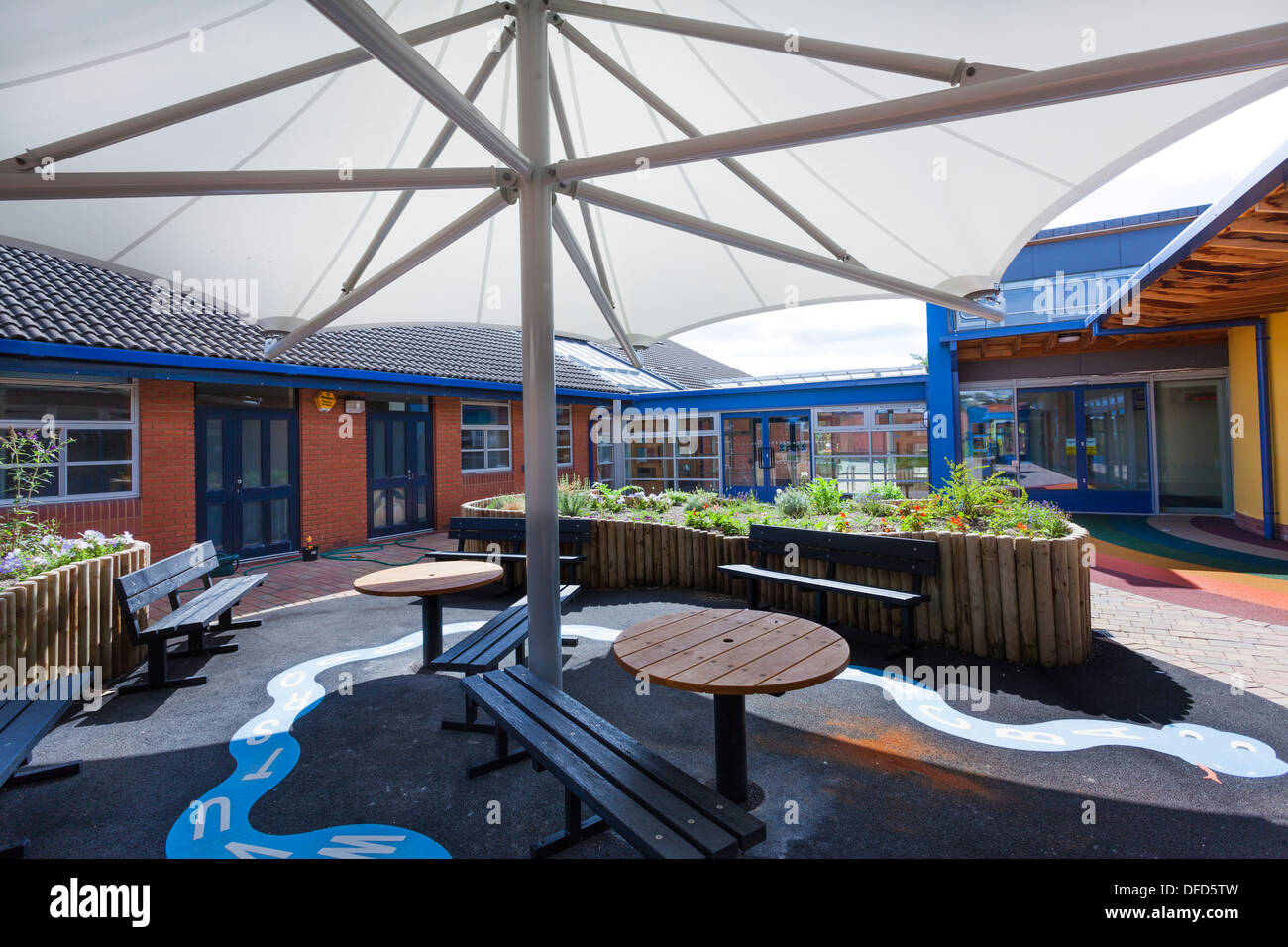 large umbrella style canopy to seats in school garden play ...