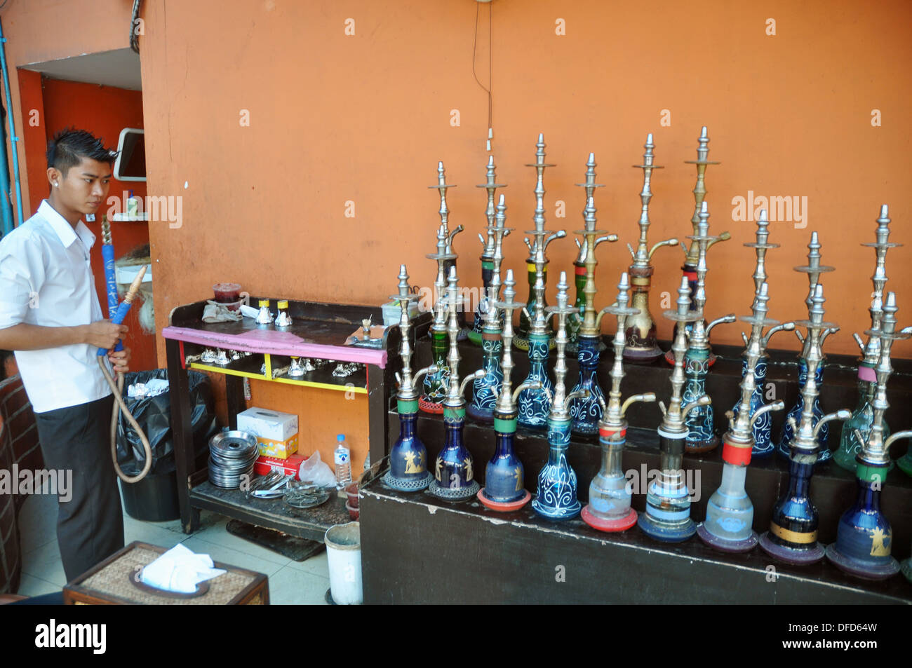 Bangkok (Thailand) a waiter preparing the hookahs in a restaurant at
