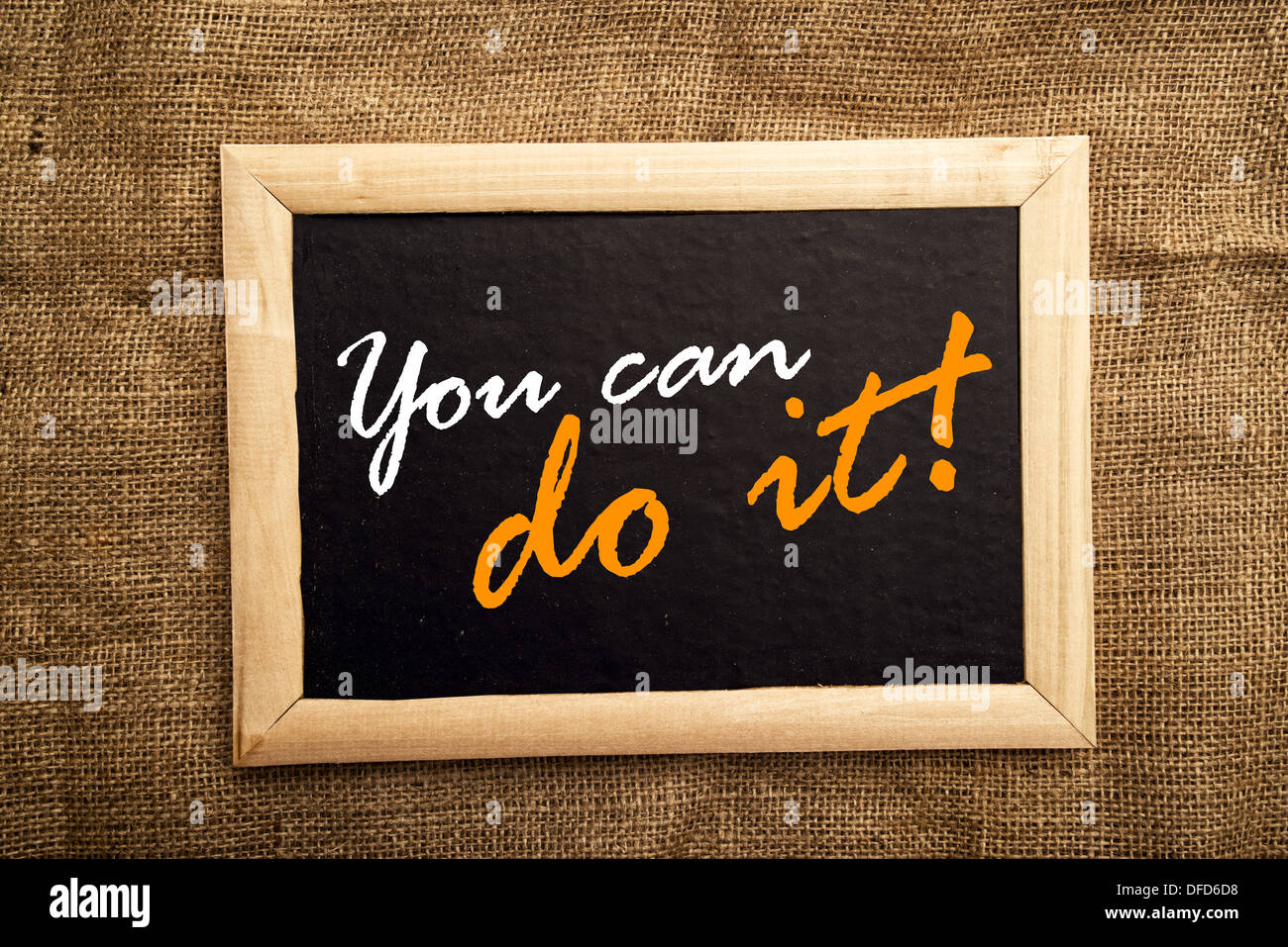 You can do it, motivational message on black board. Stock Photo