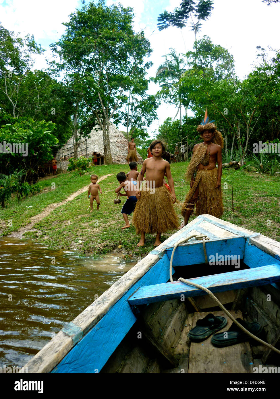Children of the Yagua Tribe play with a wooden canoe in the Amazon rain forest near Iquitos, Peru Stock Photo