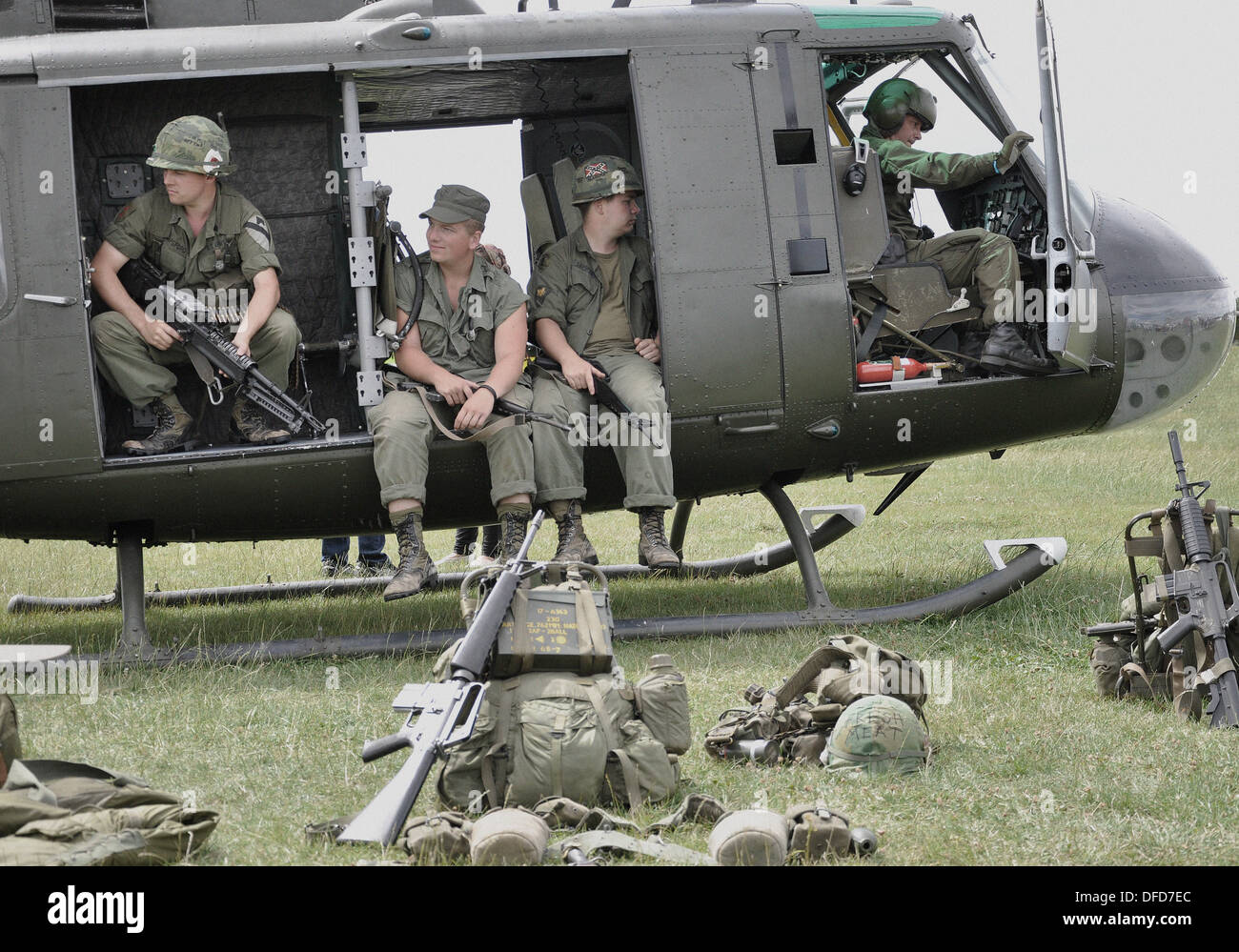 Bell UH-1 'Huey' US Army helicopter with re-enactors to represent Vietnam War scenario. Image 'aged' digitally to seventies era faded colour. Stock Photo