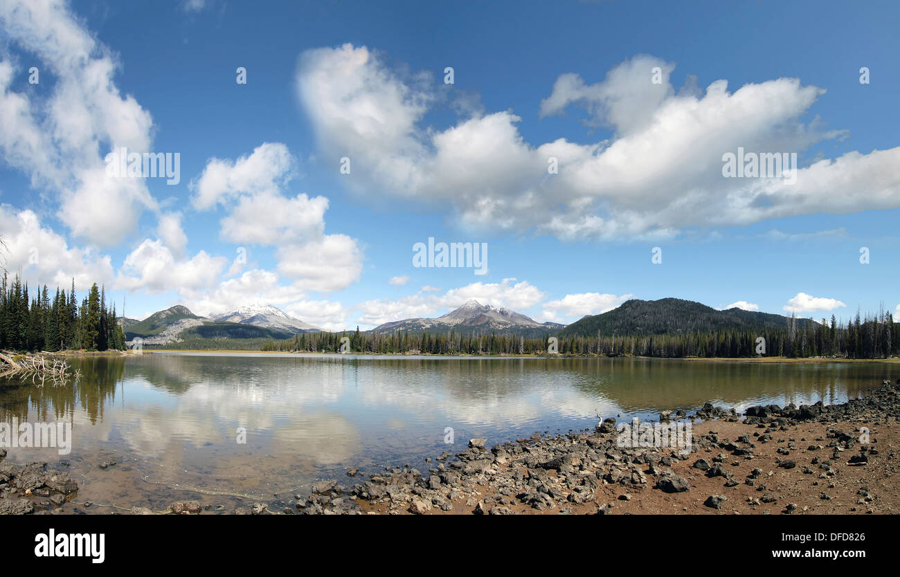 Sparks Lake in Deschutes National Forest Oregon with Mountains Blue Sky Clouds and Water Reflection Stock Photo