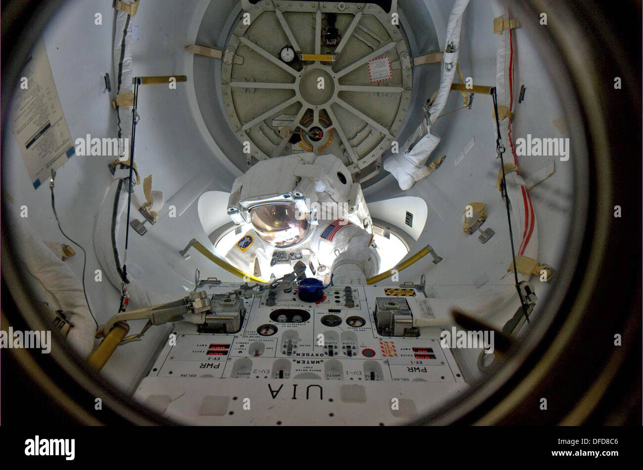 Emerging from the Quest airlock on the International Space Station, astronaut Alvin Drew began his shared spacewalking duties Stock Photo