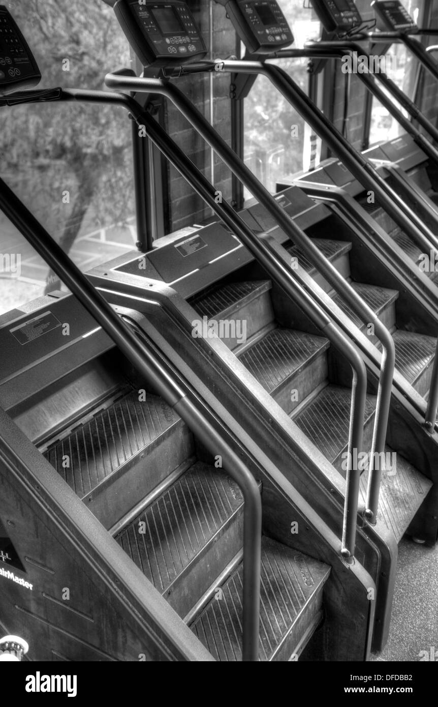 Black and white image a row of stair step machines at a commercial gym Stock Photo