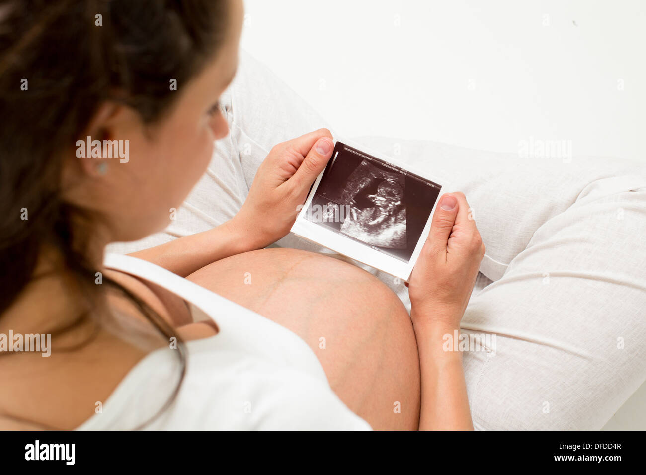 Pregnant woman looking at baby ultrasound scan Stock Photo