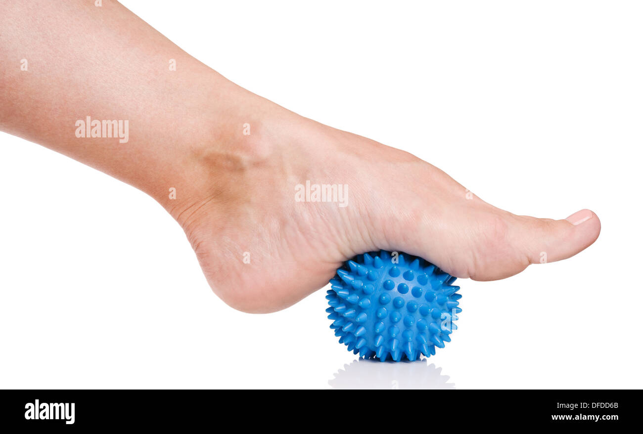 Woman's foot with spiny plastic blue massage ball isolated on white background Stock Photo