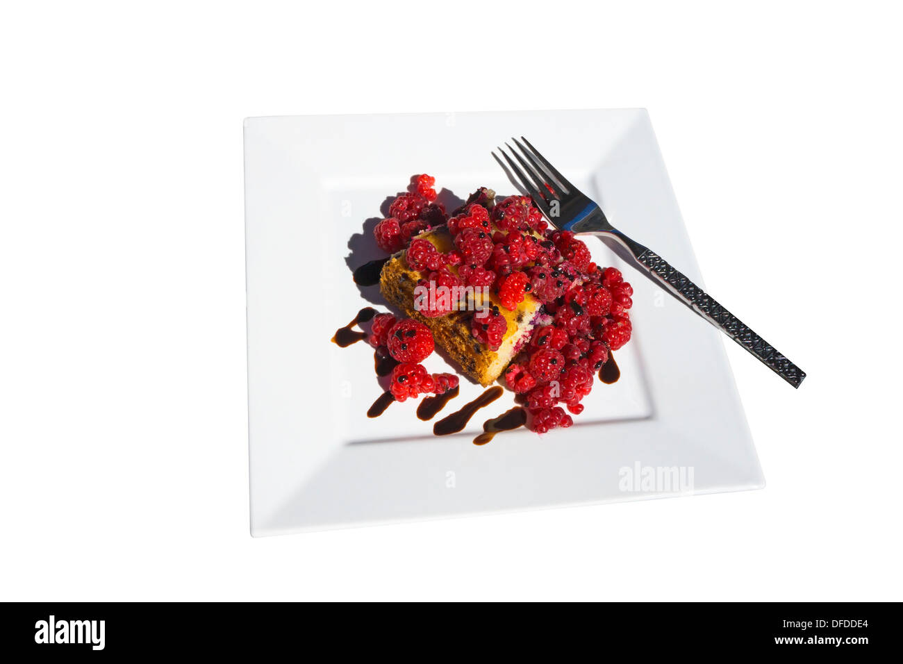 Coffee cake with fresh raspberries and chocolate drizzle  on a white plate with fork Stock Photo