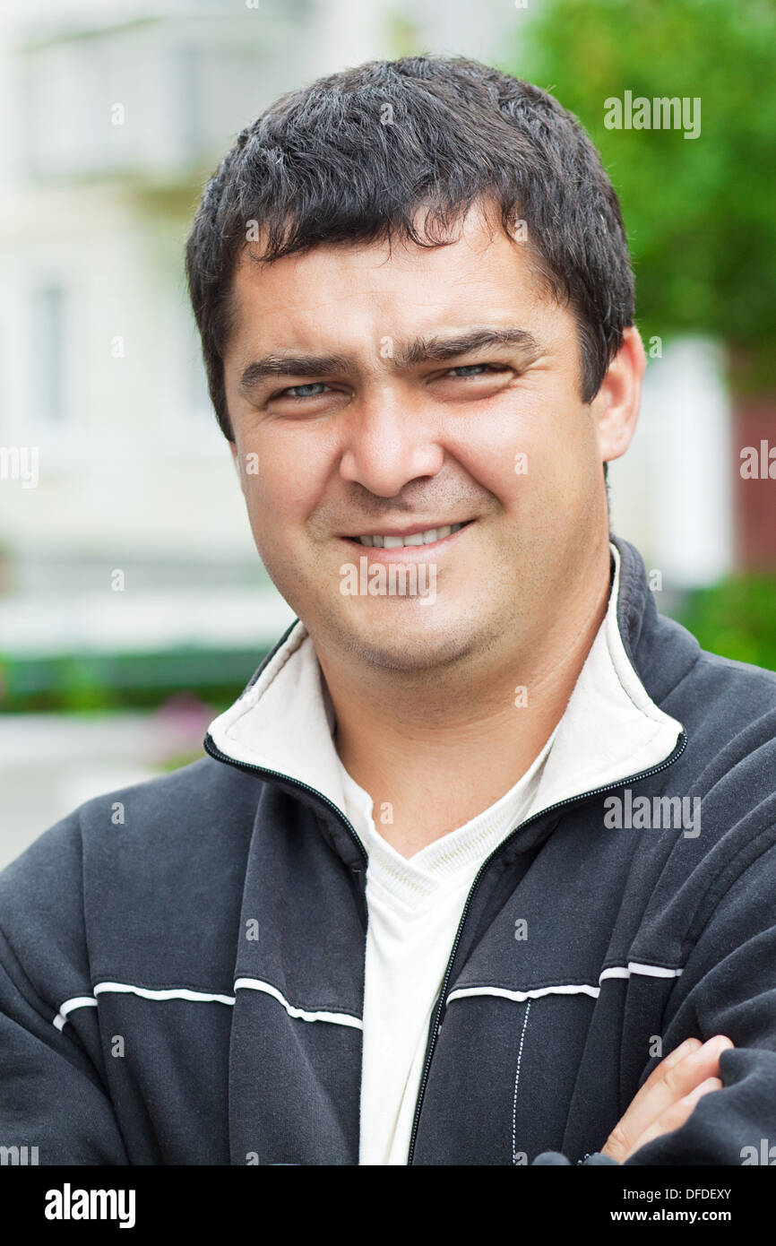 Cute male 30 years old, standing outdoors Stock Photo
