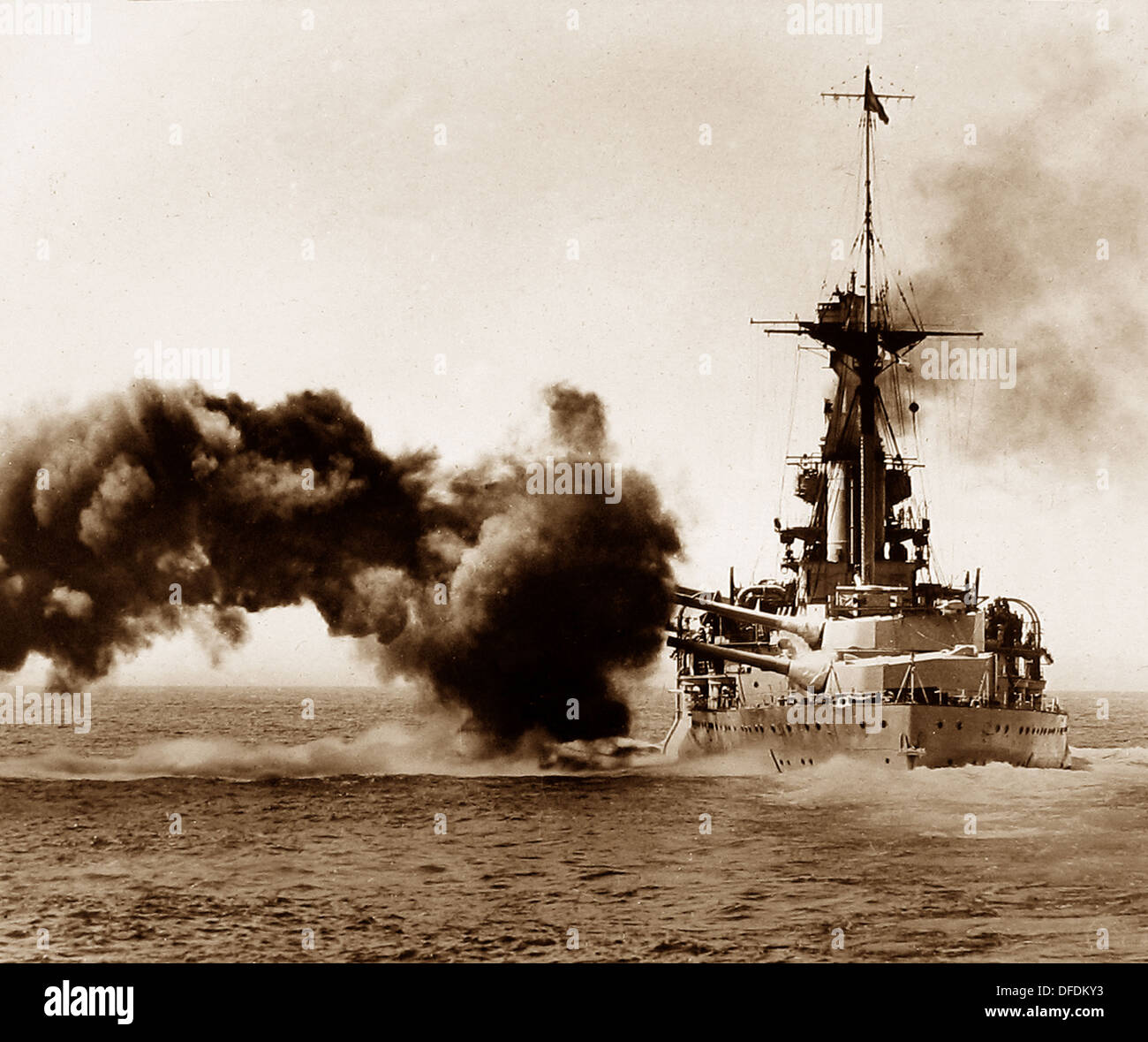 British battleship firing a broadside during WW1 Stock Photo
