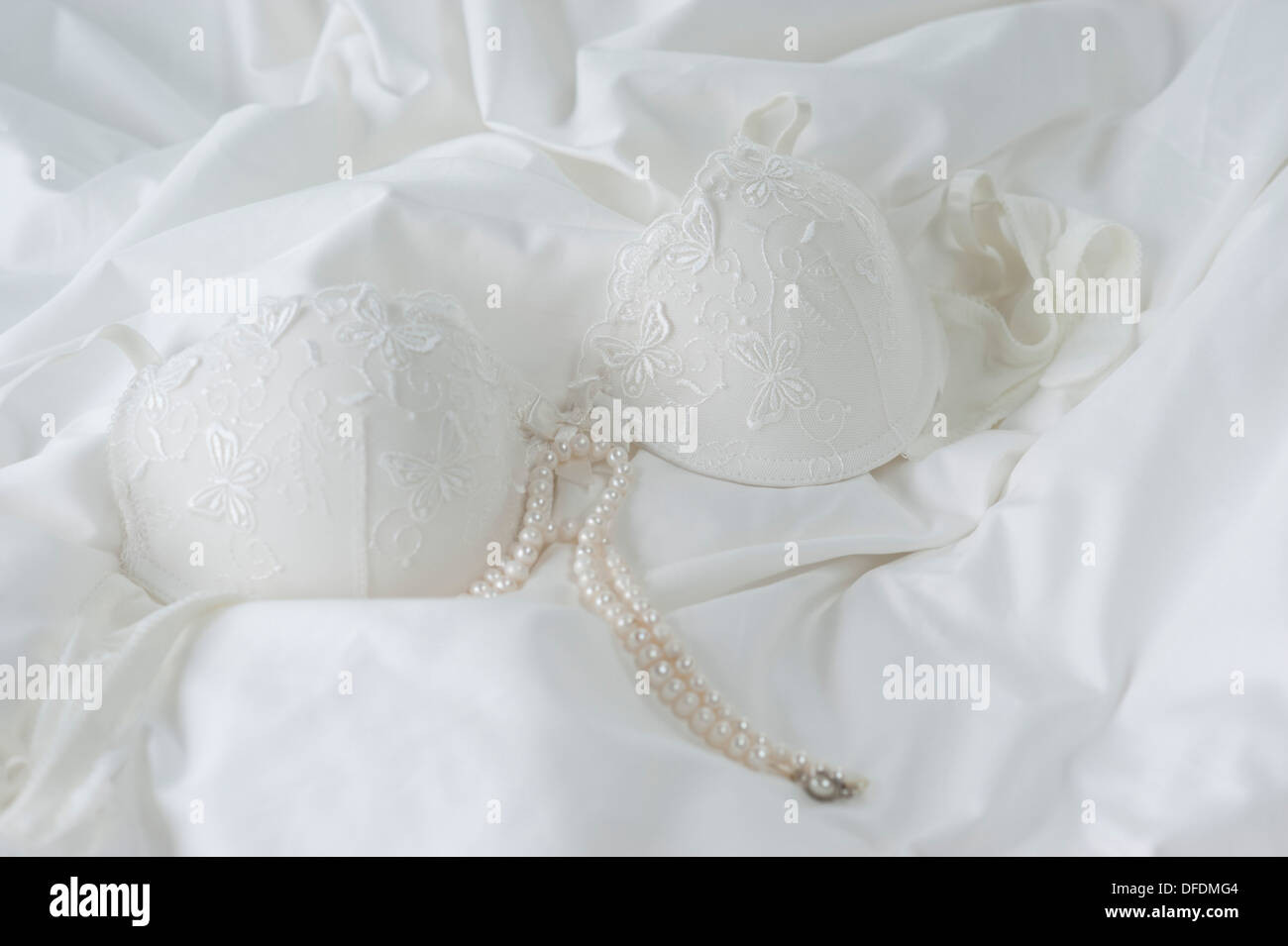 Black bra on bed sheet Stock Photo - Alamy