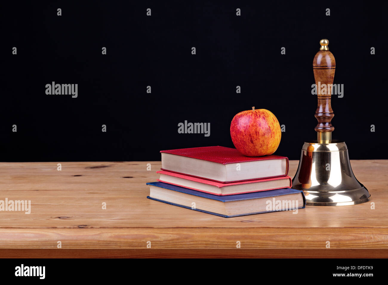 School desk with books and against a black background, add you own text. Stock Photo