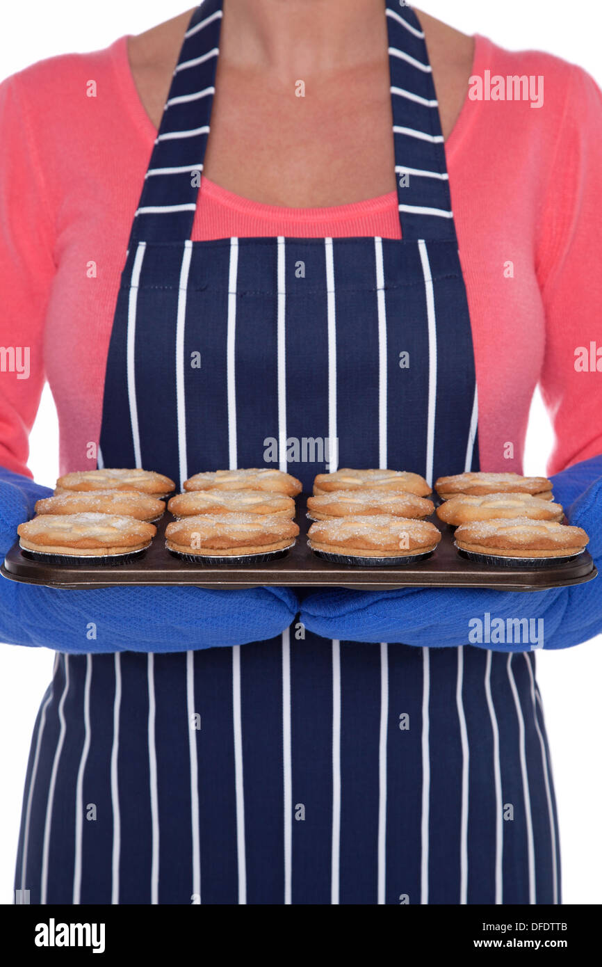 Woman holding a tray of freshly baled mince pies. Stock Photo