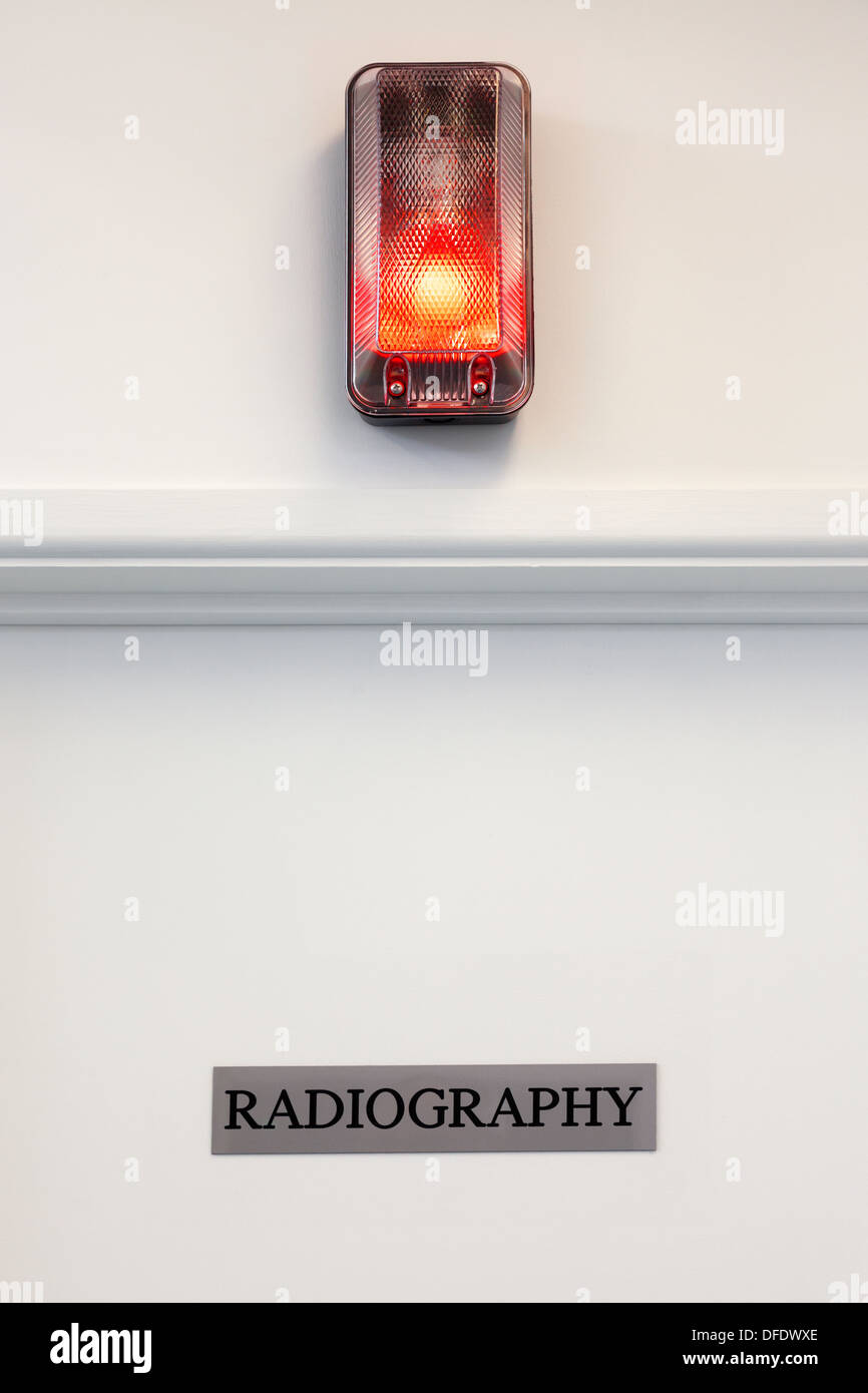 Radiography door with illuminated red light above. Stock Photo