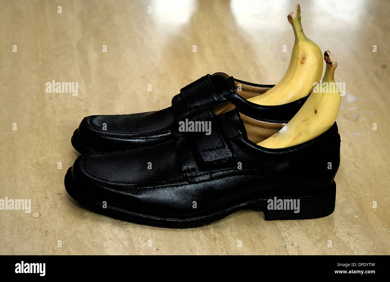 Bananas in dress shoes on hardwood floor Stock Photo