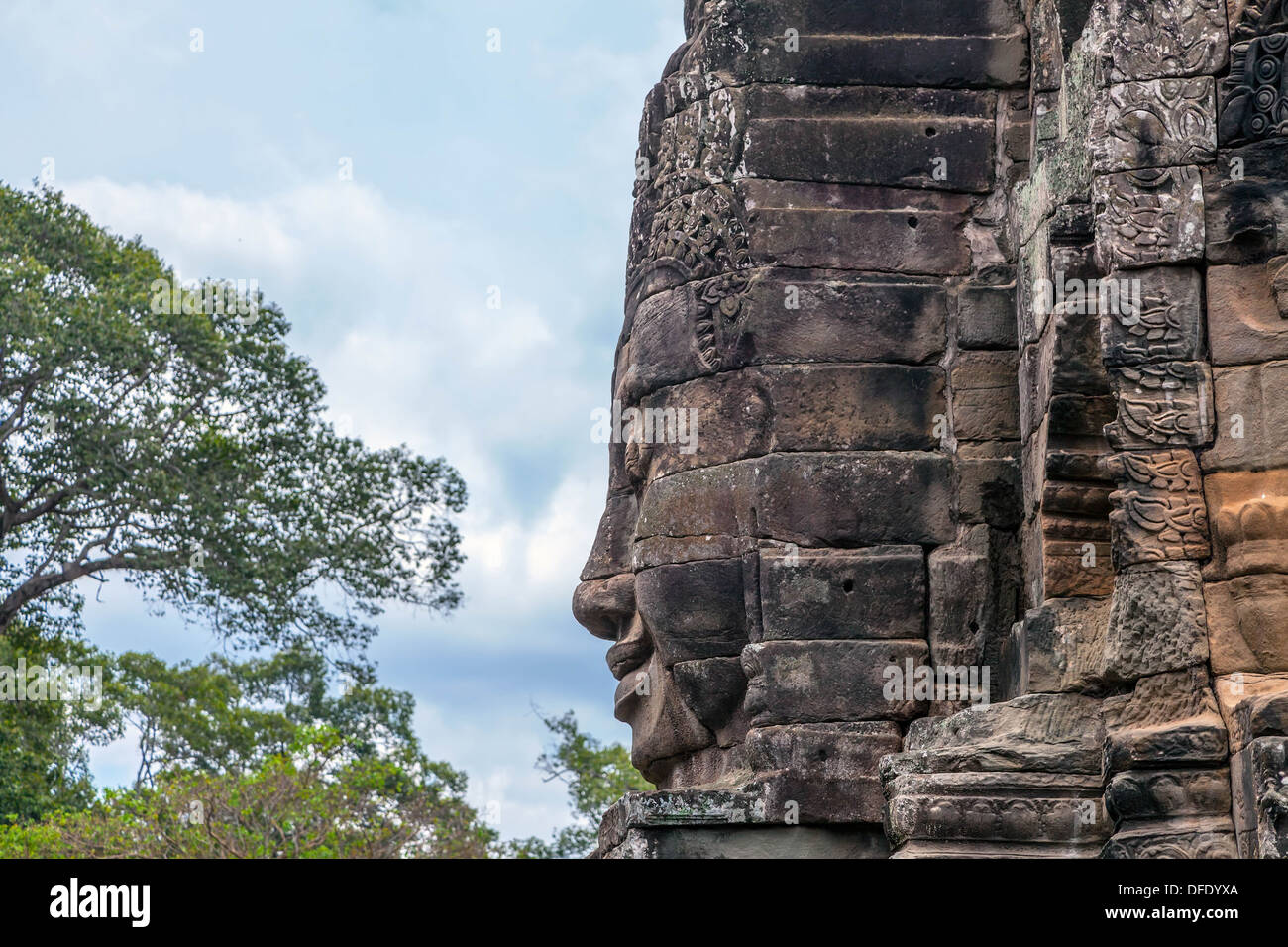 A fragment of the towers of Angkor Thom temple with image of Buddha Stock Photo